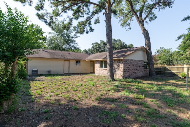 rear view of property with cooling unit