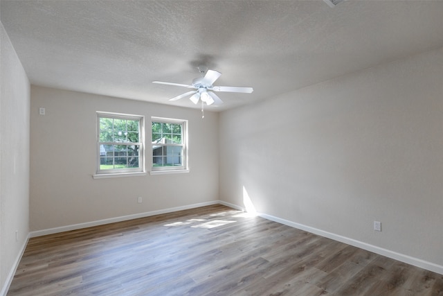 unfurnished room featuring ceiling fan, a textured ceiling, and hardwood / wood-style flooring