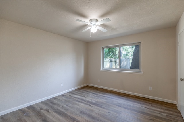 empty room with a textured ceiling, ceiling fan, and hardwood / wood-style floors