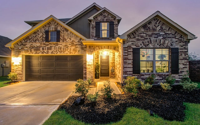 view of front of home featuring a garage, driveway, board and batten siding, and brick siding