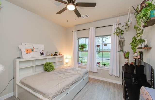 bedroom with ceiling fan and light hardwood / wood-style floors