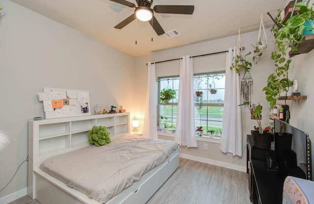 5727 Daylight Cv, Fulshear, TX 77441 - bedroom featuring baseboards, light wood-style flooring, and ceiling fan