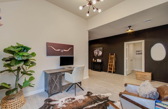 office with baseboards, visible vents, a chandelier, and wood finished floors