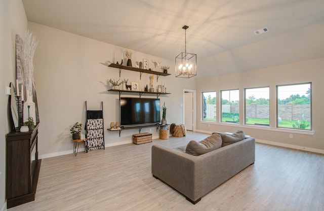 5727 Daylight Cv, Fulshear, TX 77441 - living area with a chandelier, light wood finished floors, and baseboards