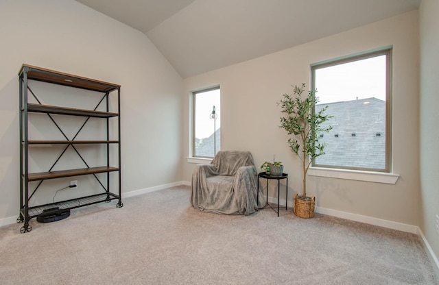 sitting room featuring lofted ceiling, carpet flooring, and baseboards