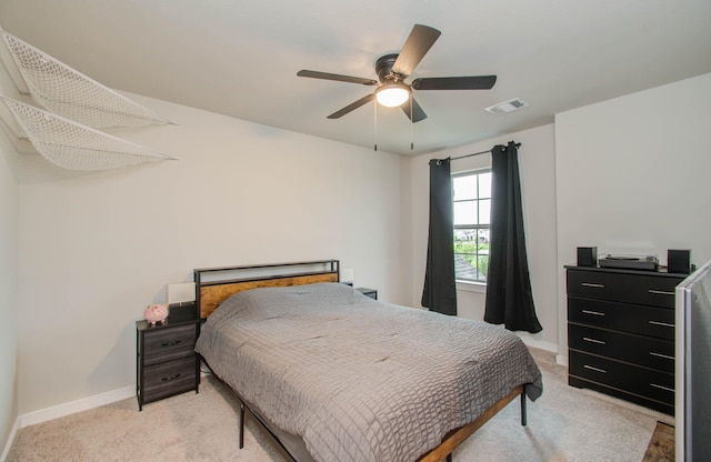 bedroom with light carpet, baseboards, visible vents, and ceiling fan