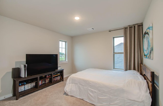 carpeted bedroom with visible vents and baseboards