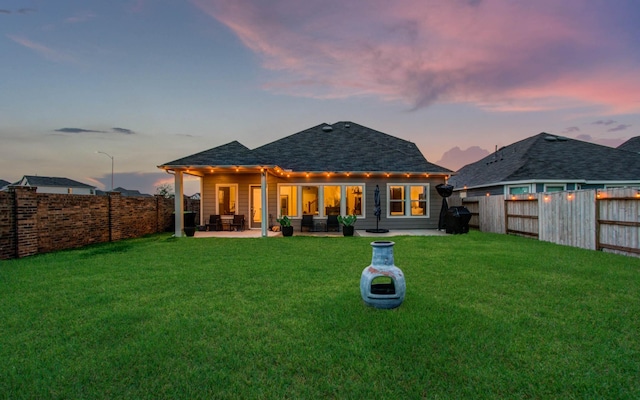 5727 Daylight Cv, Fulshear, TX 77441 - back of house with a patio area, a shingled roof, and an outdoor hangout area