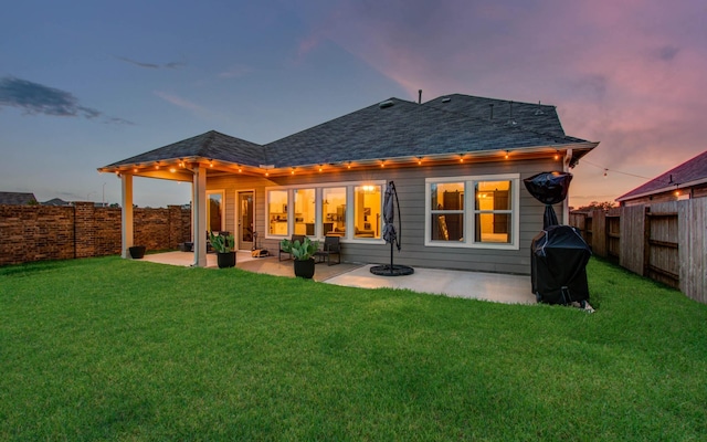 rear view of property with a patio area, a fenced backyard, and a lawn