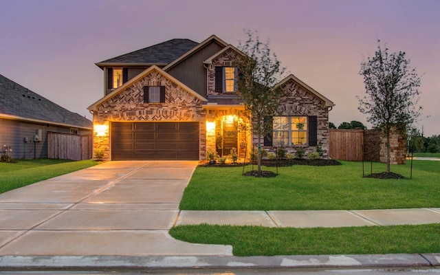 view of front of home with concrete driveway, a front lawn, board and batten siding, and fence