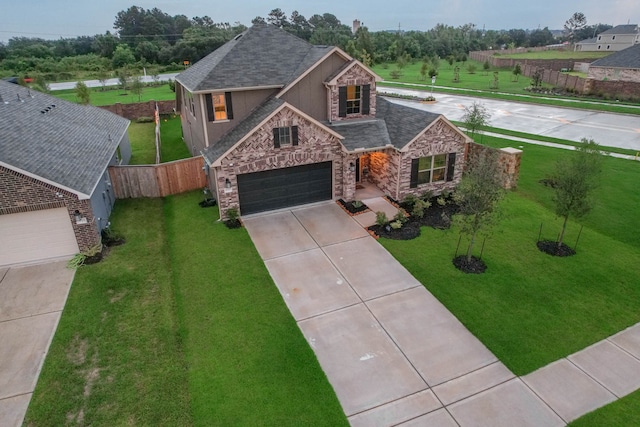 view of front of house featuring a garage, driveway, stone siding, stucco siding, and a front lawn