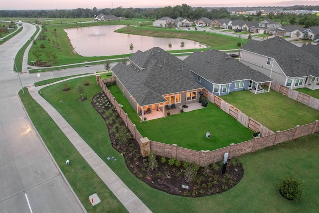 drone / aerial view with a water view and a residential view