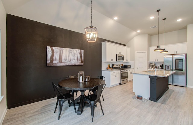 dining area featuring light wood-type flooring, baseboards, and visible vents