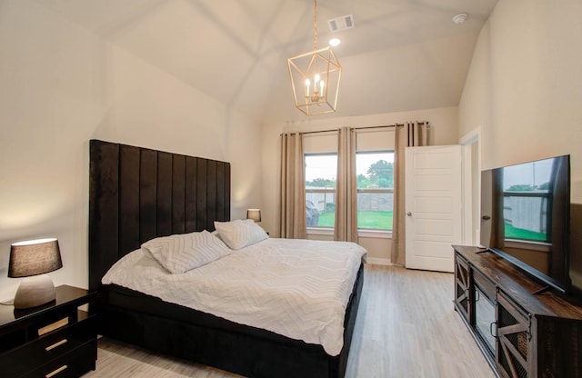 bedroom featuring a notable chandelier, visible vents, baseboards, vaulted ceiling, and light wood-type flooring