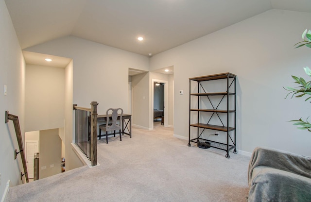 sitting room featuring lofted ceiling, carpet floors, and an upstairs landing