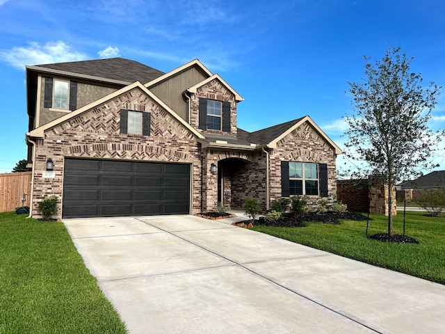 view of front facade featuring a garage, brick siding, fence, driveway, and a front yard