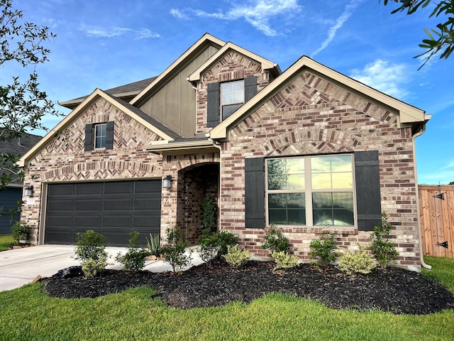 view of front of property featuring a garage, fence, concrete driveway, and brick siding