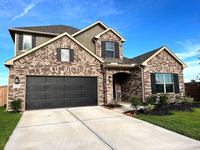 view of front facade featuring driveway, brick siding, board and batten siding, and fence