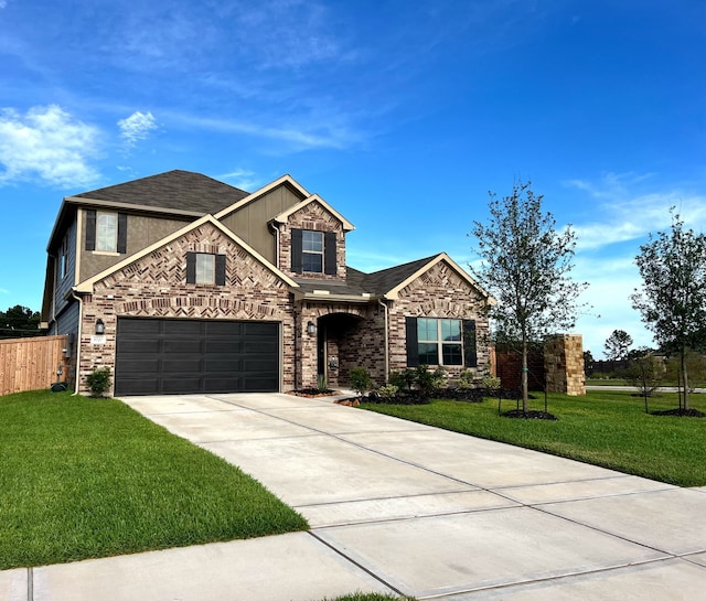 view of front of property with a garage, driveway, a front lawn, and fence