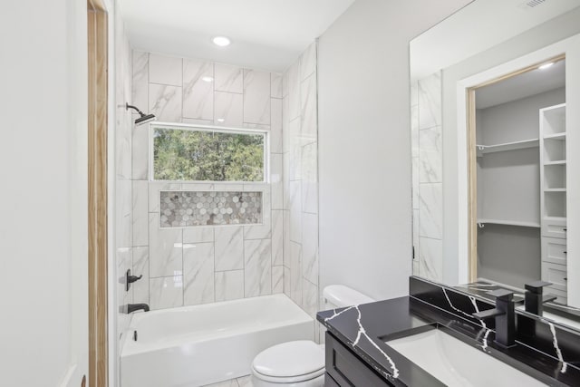 full bathroom featuring tiled shower / bath combo, vanity, and toilet