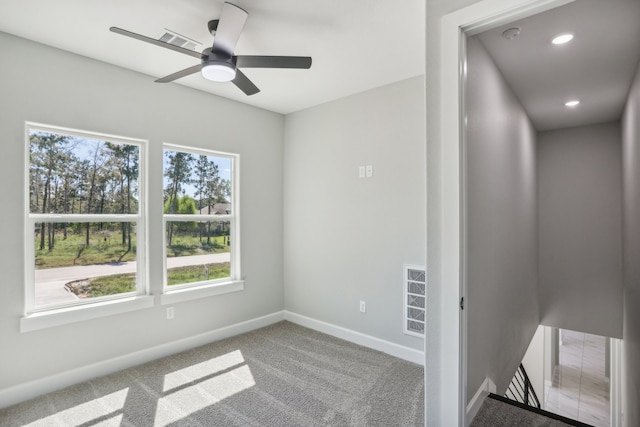 spare room with ceiling fan and carpet floors