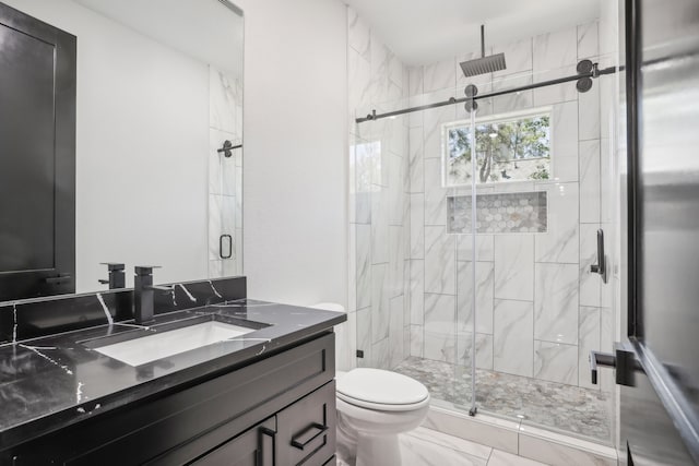 bathroom with walk in shower, vanity, and toilet