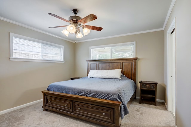 carpeted bedroom with crown molding, ceiling fan, and a closet