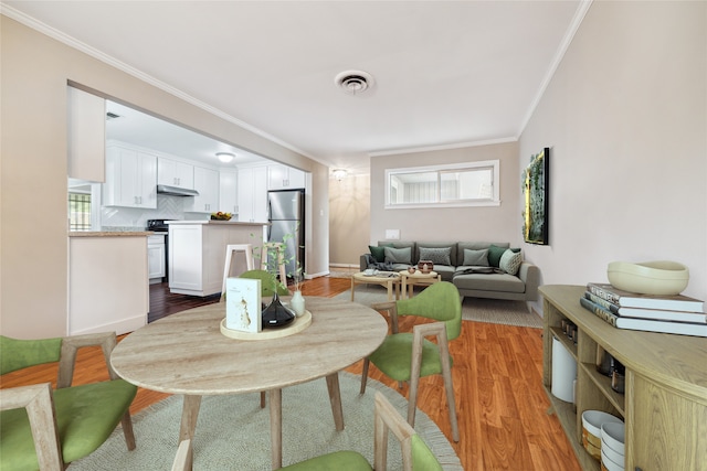 living room with hardwood / wood-style flooring and crown molding