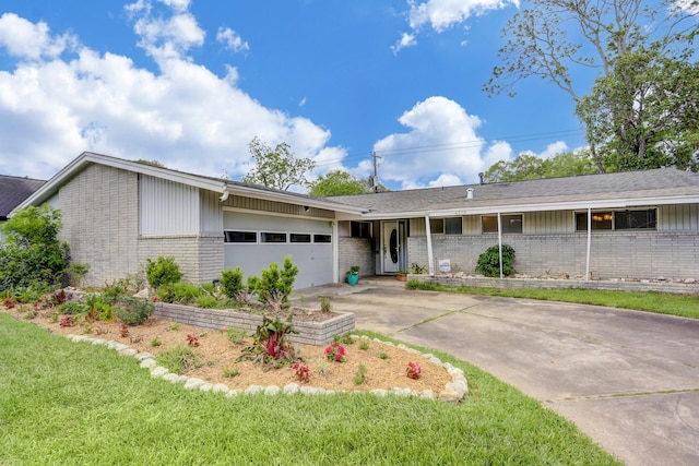 single story home featuring a garage and a front yard