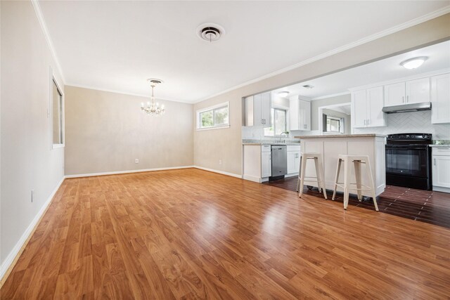 unfurnished living room featuring a chandelier, sink, light wood-type flooring, and ornamental molding