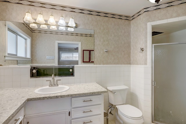 bathroom with decorative backsplash, tile walls, toilet, and vanity