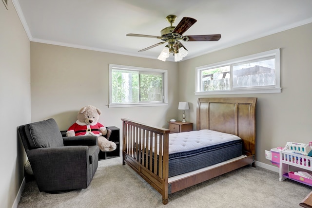 bedroom with ornamental molding, light colored carpet, multiple windows, and ceiling fan