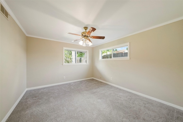 empty room with crown molding, ceiling fan, and carpet flooring