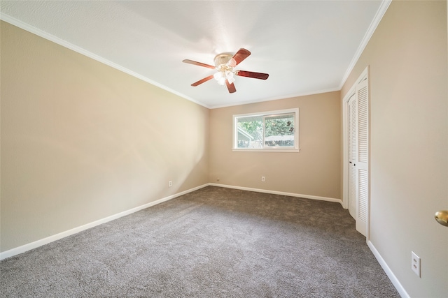 carpeted spare room featuring ceiling fan and ornamental molding