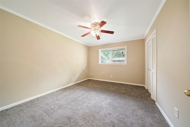 carpeted spare room featuring crown molding and ceiling fan