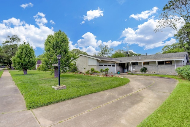 ranch-style home featuring a garage and a front lawn