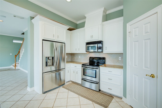 kitchen featuring white cabinetry, appliances with stainless steel finishes, ornamental molding, and light tile patterned floors