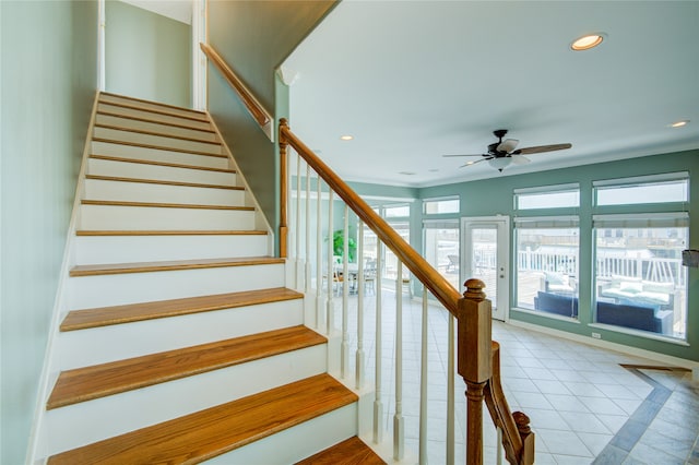 stairs with tile patterned flooring, ornamental molding, and ceiling fan