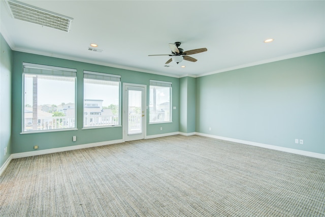 unfurnished room with carpet, ceiling fan, and ornamental molding