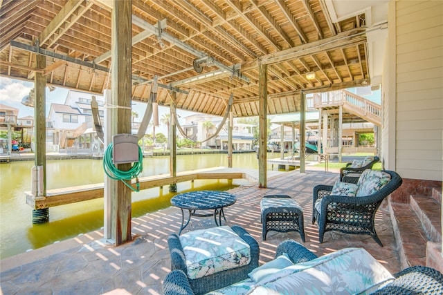 view of patio / terrace featuring a water view and a boat dock