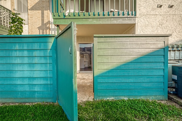 entrance to property featuring cooling unit and a balcony