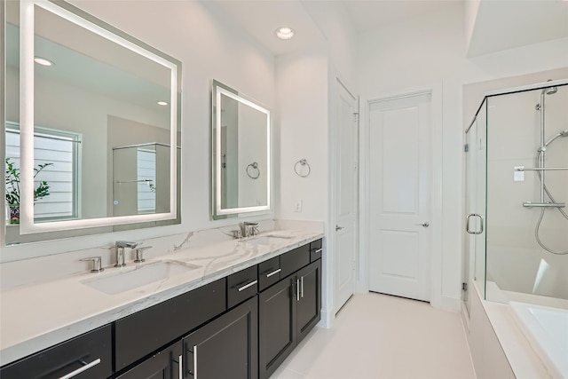 bathroom with dual vanity, shower with separate bathtub, and tile patterned flooring