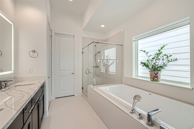 bathroom featuring plenty of natural light, vanity, and shower with separate bathtub