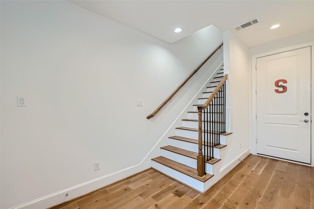 stairs featuring light hardwood / wood-style floors