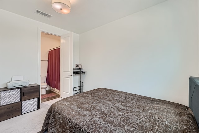 carpeted bedroom with ensuite bathroom