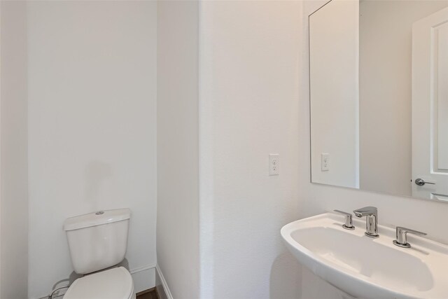 bathroom with toilet and sink