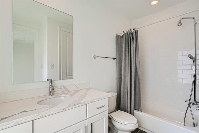 full bathroom featuring vanity, shower / bath combo with shower curtain, and toilet