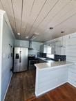 kitchen featuring wooden ceiling, stainless steel fridge with ice dispenser, and dark hardwood / wood-style flooring