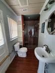 bathroom featuring wood-type flooring and a healthy amount of sunlight