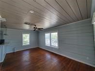 interior space featuring dark wood-type flooring and wooden ceiling